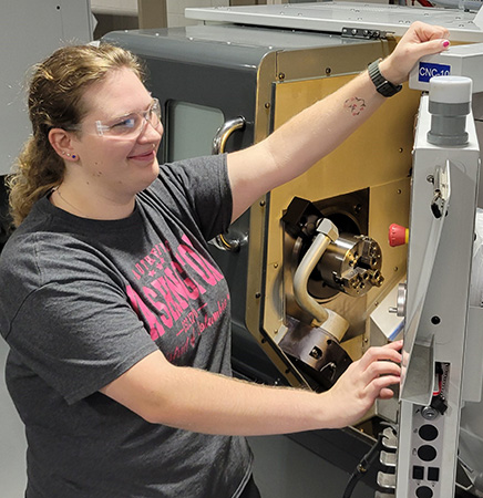 CNC Automation Technician student Autumn Robley works on the lathe, which she says is her favorite machine.