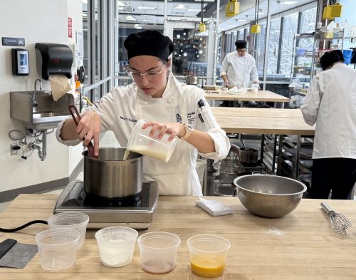 A student works on a recipe during a culinary course at Lakeshore College.