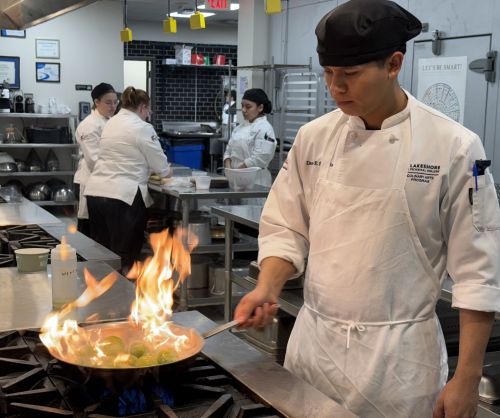 A student cooks during a culinary class at Lakeshore College.