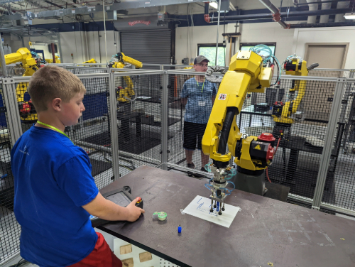 A kid using a machine and learning
