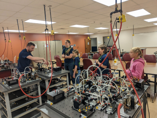 A group of people in a room with machines
