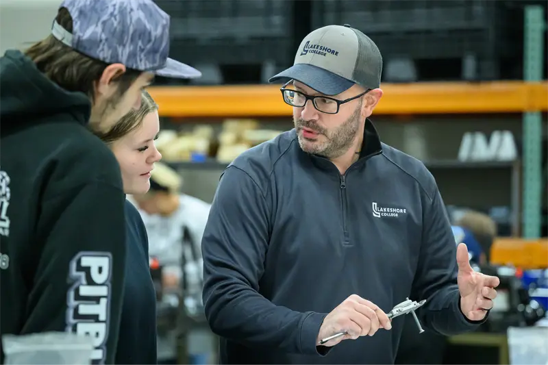 Maintenance Mechanic faculty member Mark Sieben discussing a lesson with students in a classroom.