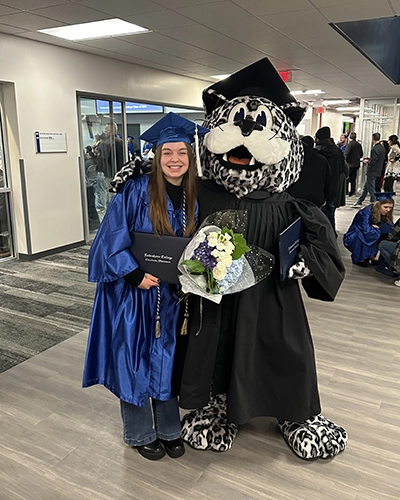 Student with Lenny on graduation day.
