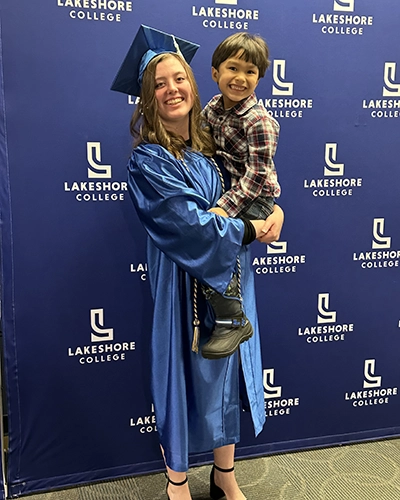Student with her family member on graduation day.